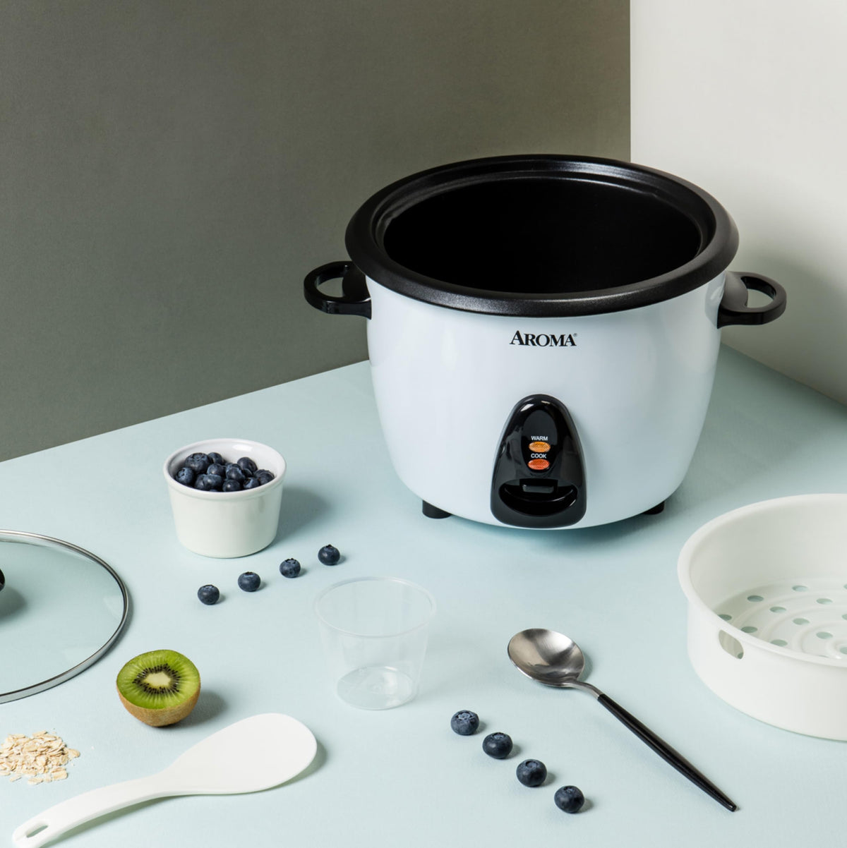 AROMA ARC-360-NGP rice cooker open pot with steam rack in use.