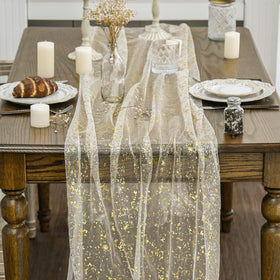 Artoid Mode glitter finish on beige-gold gauze runner enhances festive table settings