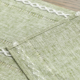 Artoid Mode sage green table runner on a dining table for gatherings.