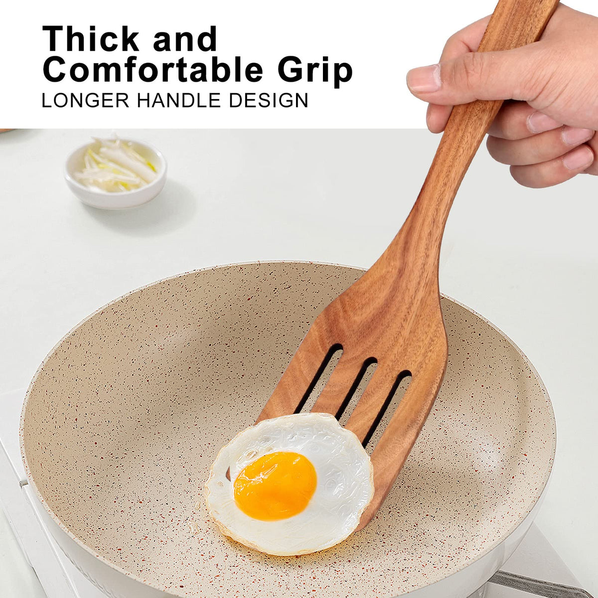 Ayiaren teak slotted spatula allowing steam to escape while turning food