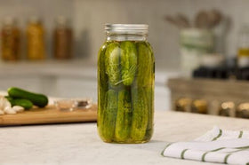 Ball 64oz jars used for fresh juice storage in kitchen.