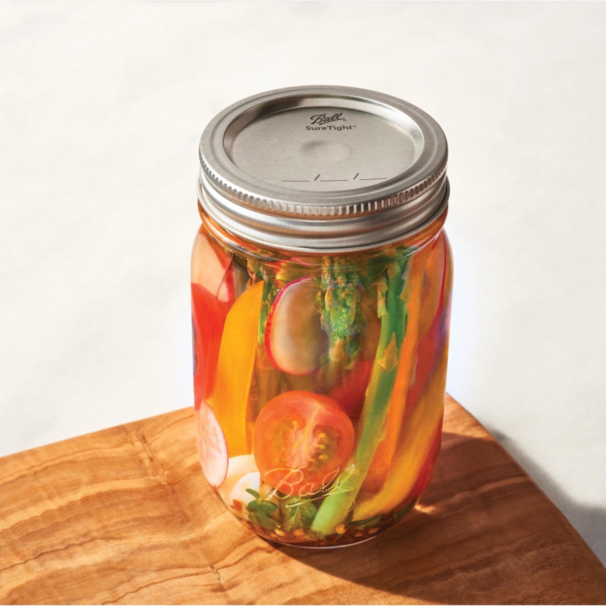Ball Regular Mouth Lids fit glass Mason jars for reliable sealing and storage.