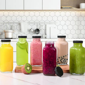 Benestanti glass bottle with lid on counter, ideal for on-the-go drinks.