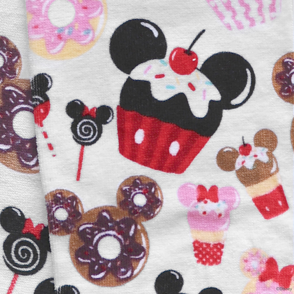 Disney kitchen towels resting on an oven handle for whimsical, ready-to-use decor.