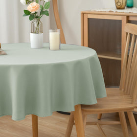 Holiday party setting featuring sage tablecloth adds festive, sophisticated touch.