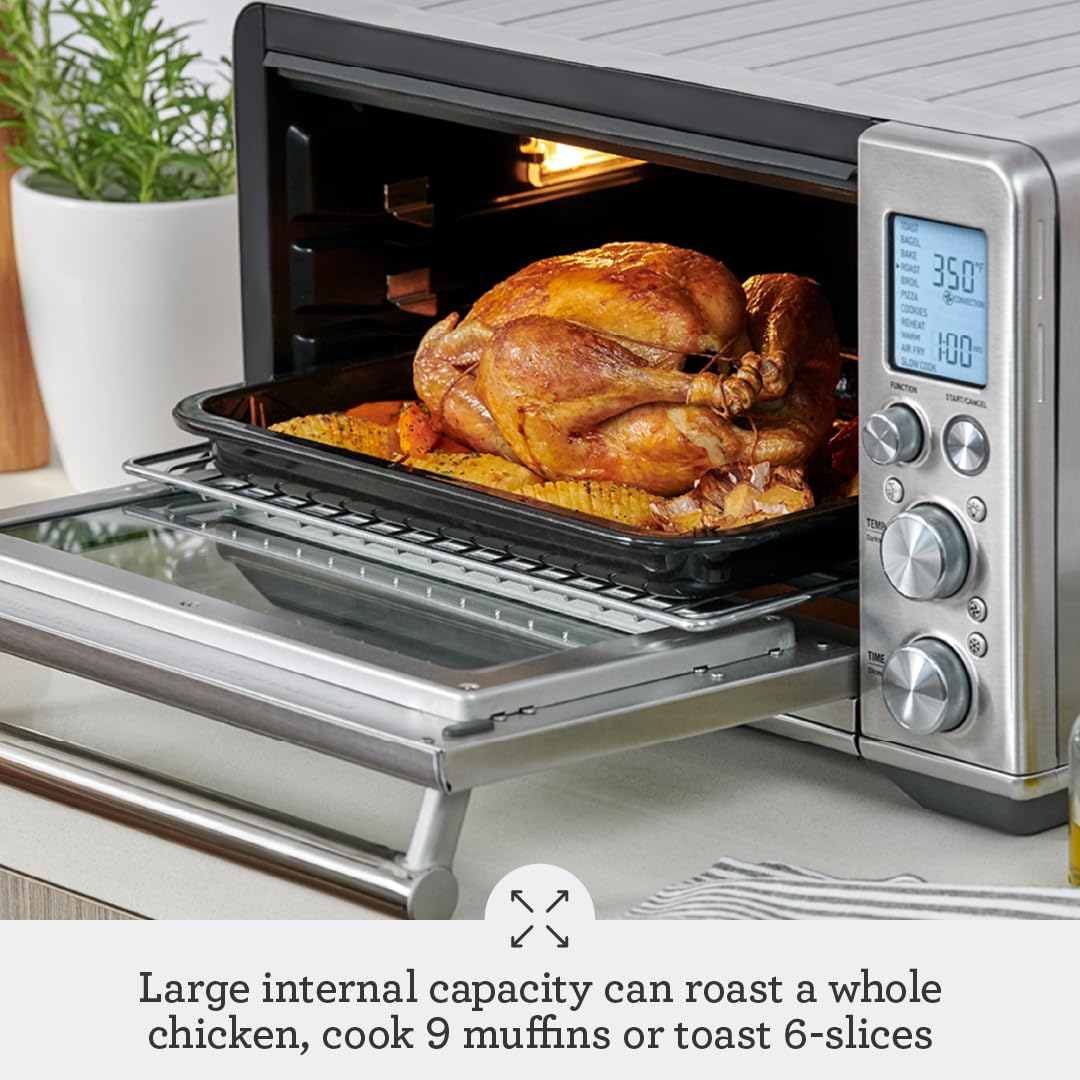 Breville BOV860DBL interior with light on, showcasing precise cooking visibility.
