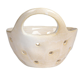 Creative Co-Op Cream Stoneware Colanders on shelf beside a plant for decor