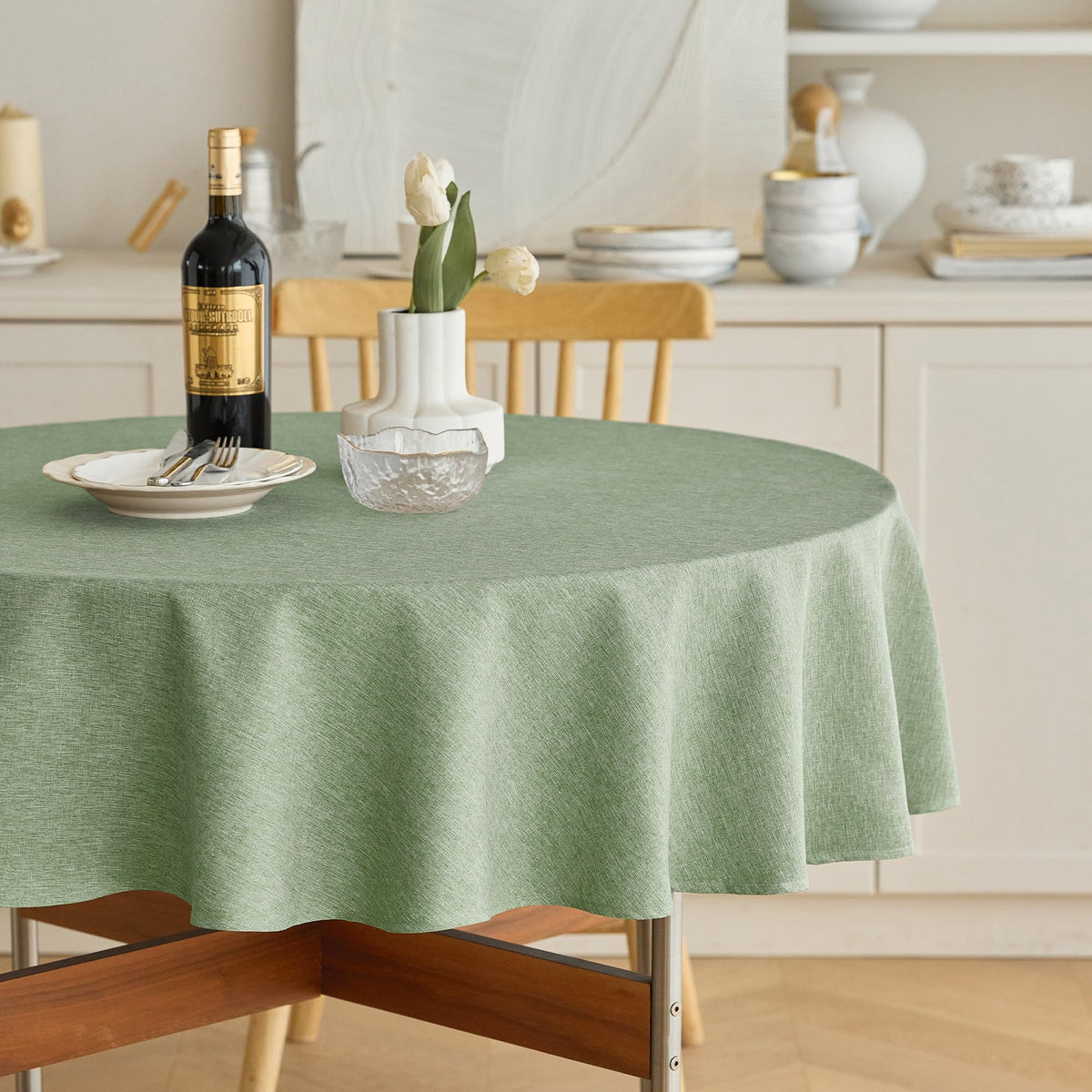 Decorelia faux linen round tablecloth in sage green for 4 to 6 seats on a 70 inch table