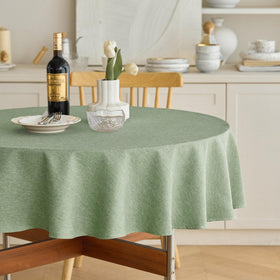 Decorelia faux linen round tablecloth in sage green for 4 to 6 seats on a 70 inch table