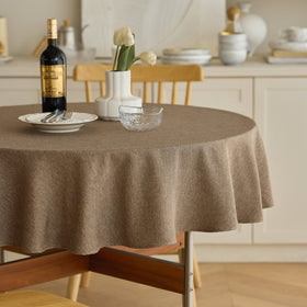 Decorelia waterproof round tablecloth in coffee covers two to four seat tables and protects surfaces.