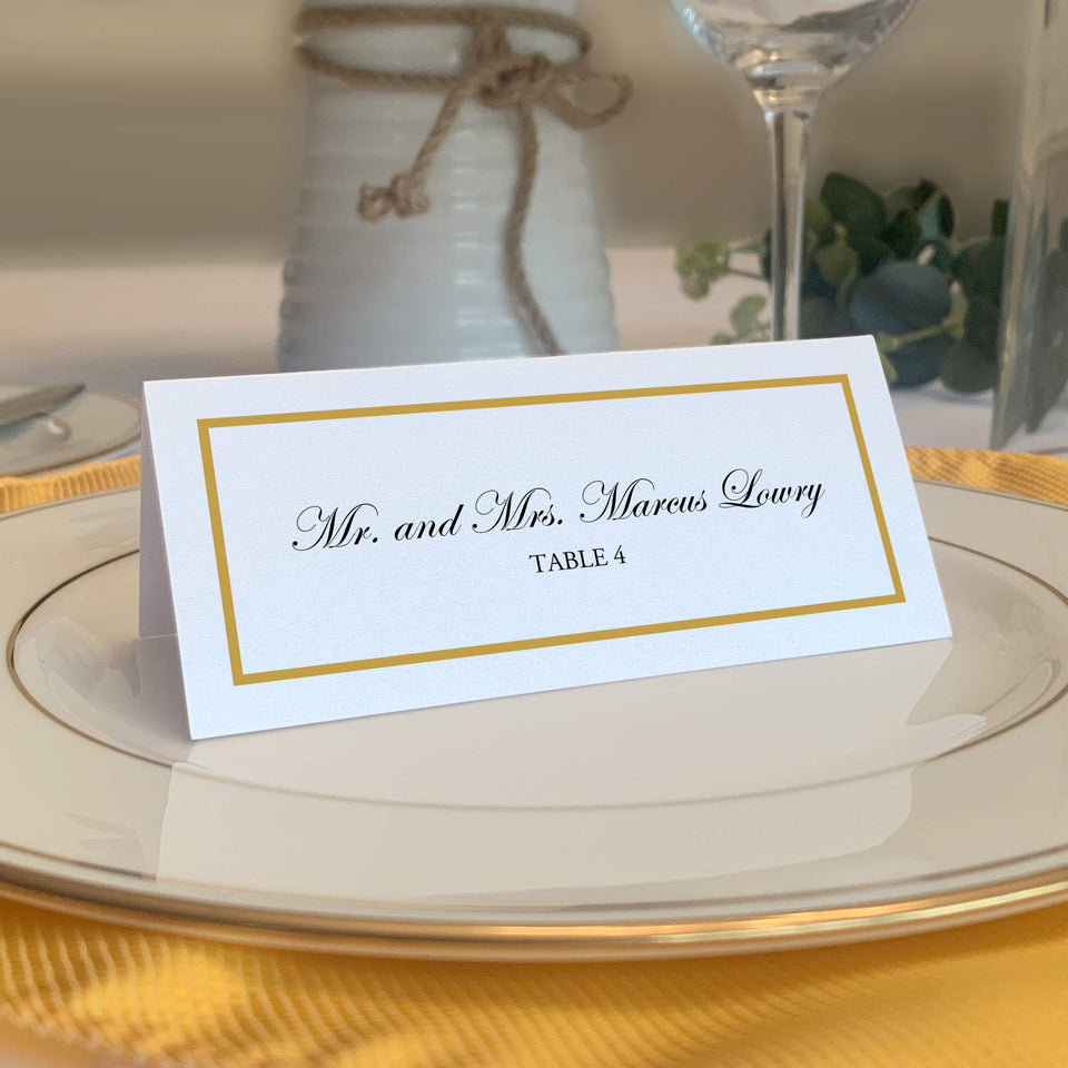 Documents and Designs gold place card front with single-line border for weddings.