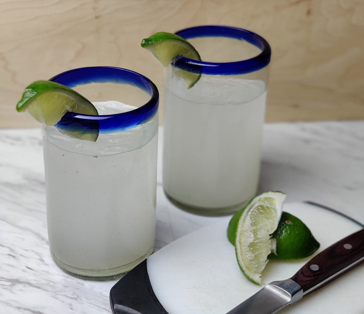 Dos Sueños traditional blue rim Mexican glassware adds authentic charm to table.