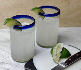 Dos Sueños traditional blue rim Mexican glassware adds authentic charm to table.