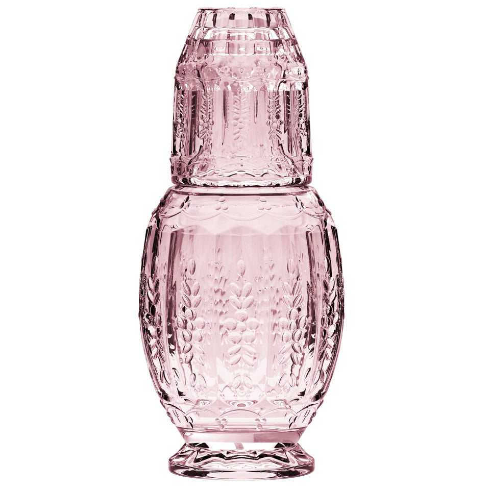 Elle Decor vintage bedside water carafe with pink tumbler on nightstand for convenient hydration.