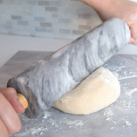 Fox Run rolling pin resting on wooden cradle for easy storage