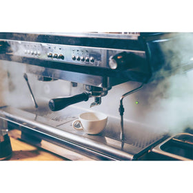 Gaggia decalcifier packaging shown beside espresso machine to encourage routine maintenance.