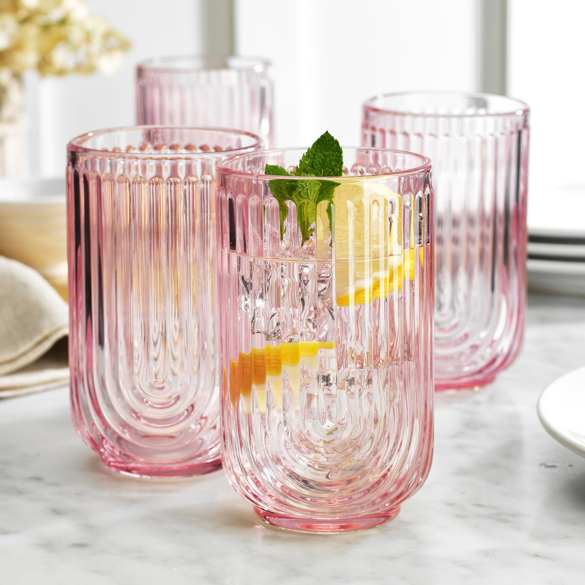 Glaver's pink arch highball glass adds a vibrant touch for entertaining.