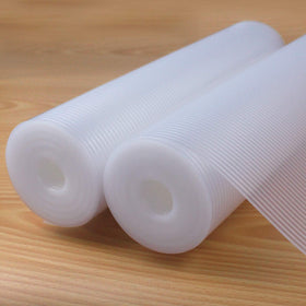 Glomen shelf liner with non-slip textured surface protects items on shelves.