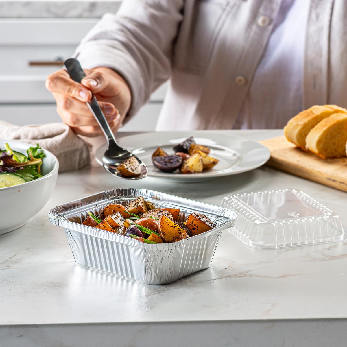 GUSTO clear dome lids on foil pans protect and showcase meals.