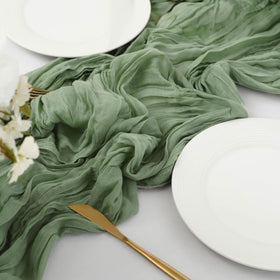 Haewlear cheesecloth runner on cake table adding delicate texture.