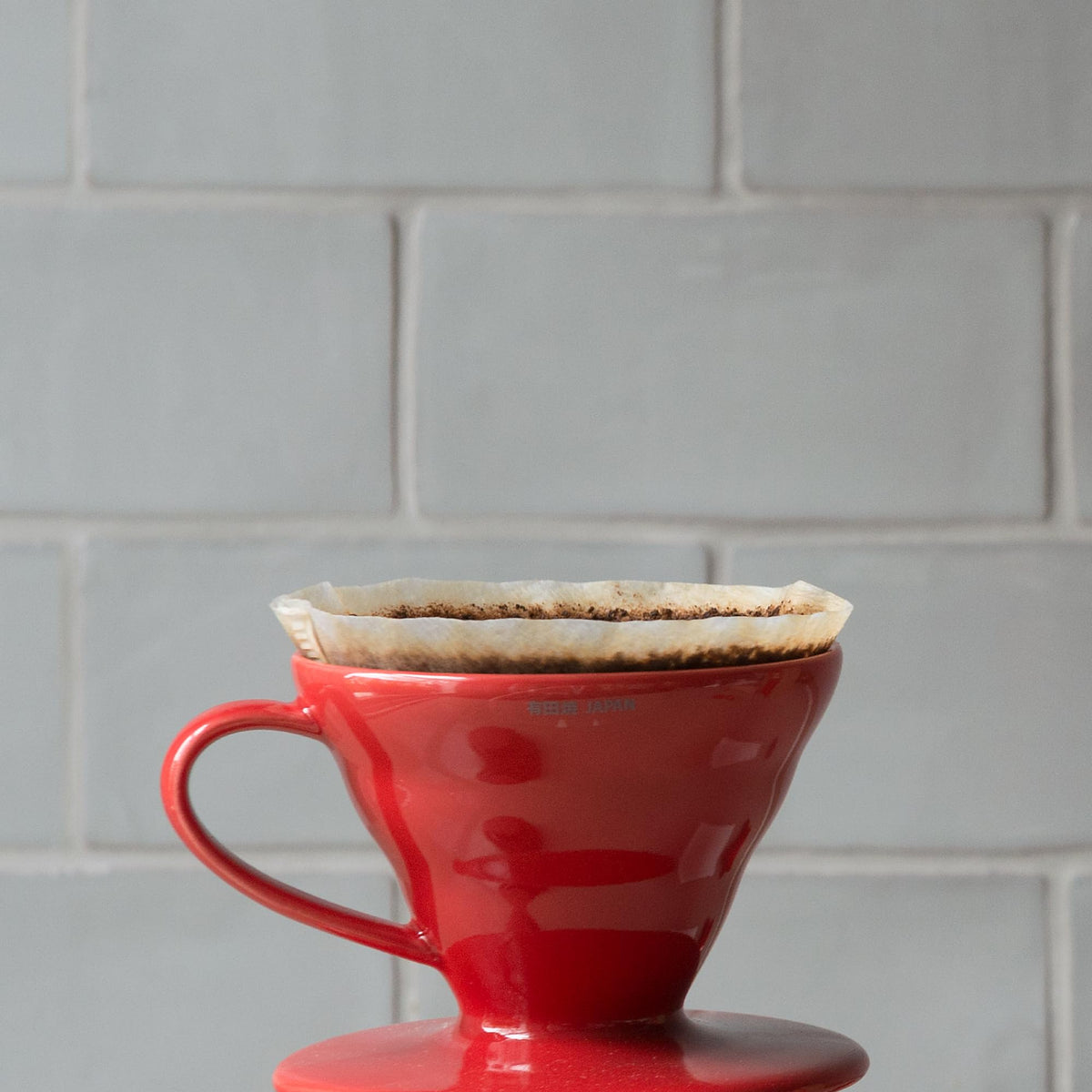 Hario V60 ceramic coffee dripper White, texture close-up, reliable heat retention for steady brewing.