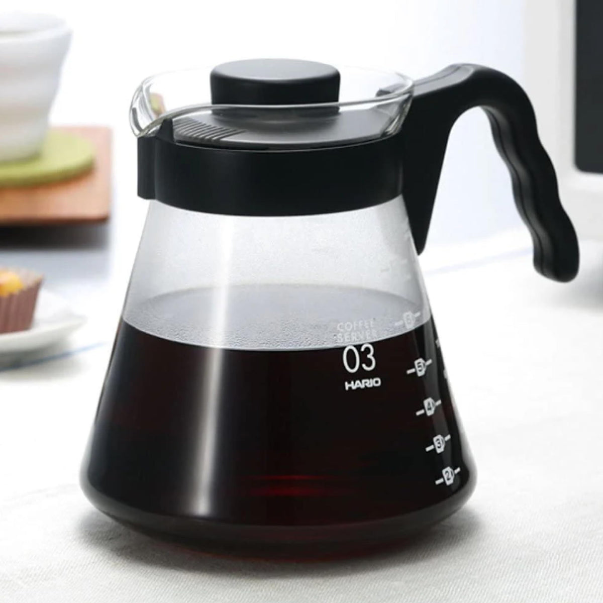 Hario V60 glass coffee server handle enables safe, controlled pouring.