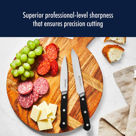 Henckels Solution 4-inch knife slicing meat with clean edges.