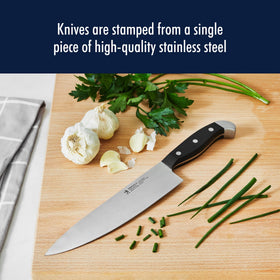 HENCKELS 8-inch chef knife slicing herbs with precision and control.