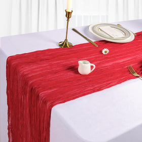Heneger wedding table setup with red runners creates a romantic atmosphere.
