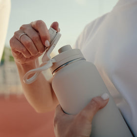 Hydrapeak 32oz bottle held in hand, ready for workouts.