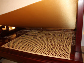 ifrmy cushion grip pad in use on a couch for tidy seating.