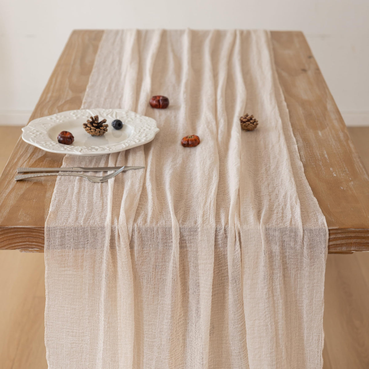 Keketoarrange beige gauze table runner on dining table elevates casual meals.