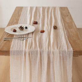 Keketoarrange beige gauze table runner on dining table elevates casual meals.