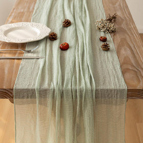 Keketoarrange bridal shower setup featuring sage green cheesecloth runner