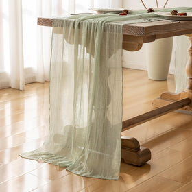 Keketoarrange sage-green cheesecloth runner for Easter boho table setting.