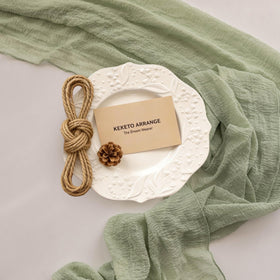 Keketoarrange sage green boho feast setup with the table runner.