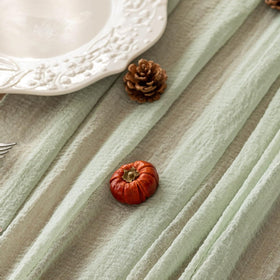 Keketoarrange sage green table runner at a wedding arch showcasing versatile decor.