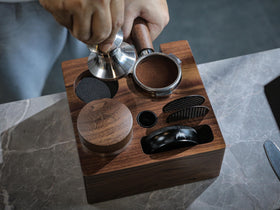 KNODOS walnut portafilter holder neatly stores a portafilter and accessories on a compact base