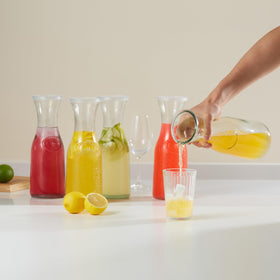KooK Glass Carafe hourglass-shaped glass carafe enhances elegant table presentation.