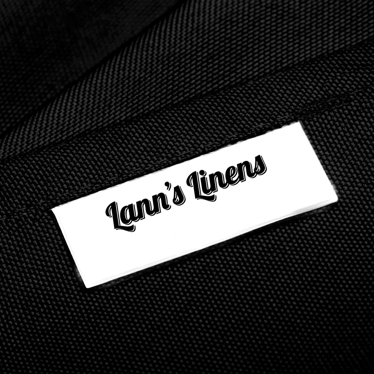 Lann's Linens tablecloth on a banquet table at a wedding setup in black