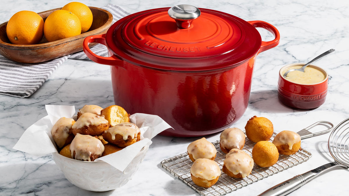 Interior enamel of Le Creuset highlights browning and simmer progress.