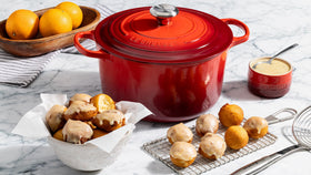 Interior enamel of Le Creuset highlights browning and simmer progress.