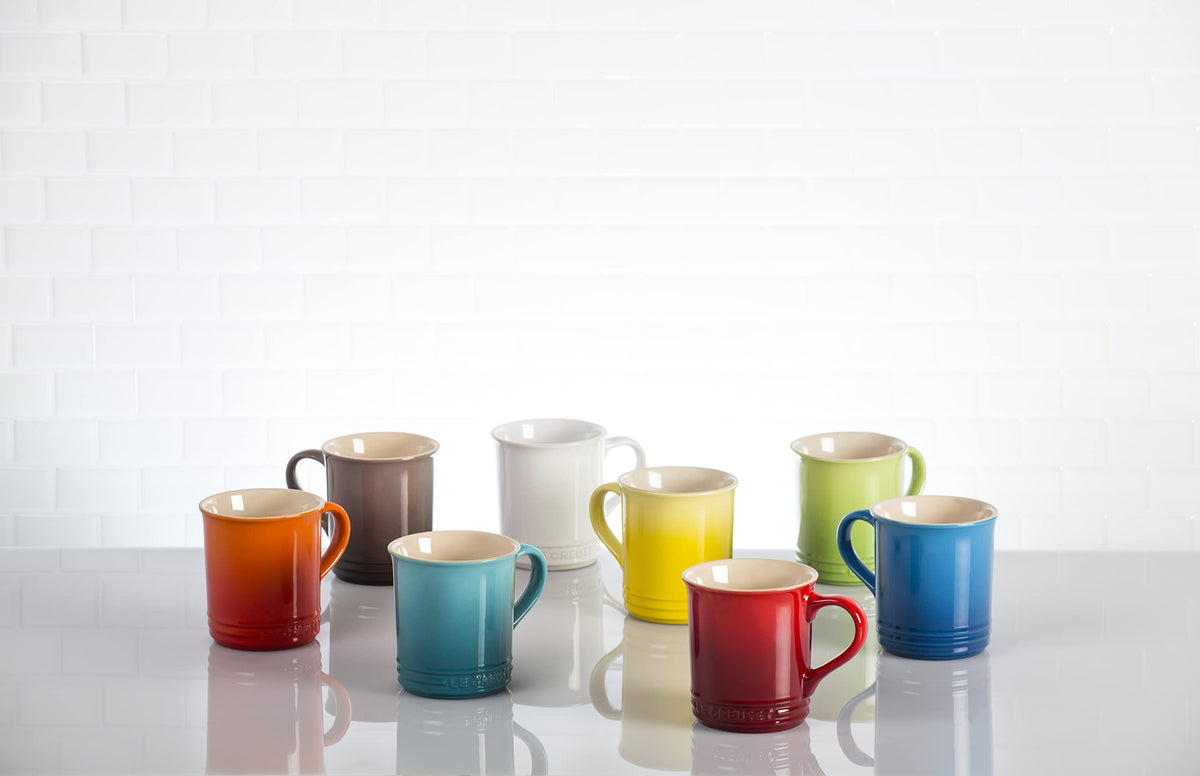 Le Creuset Vancouver mug held in hand, highlighting comfortable grip and color.