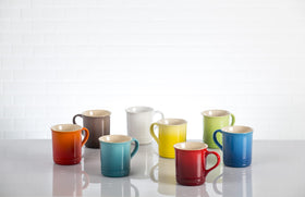 Le Creuset Vancouver mug held in hand, highlighting comfortable grip and color.