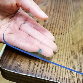 LovePads Clear Table Cover protecting a dining table from spills and stains.