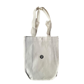 Lululemon new white gym tote bag front view, lightweight and reusable for lunch or gym gear.