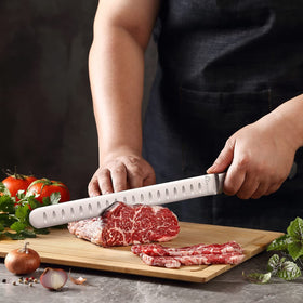 MAIRICO Brisket Slicing Knife slicing brisket on a cutting board.