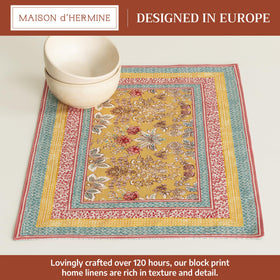 Maison d'Hermine placemats showcasing watercolor artwork on table