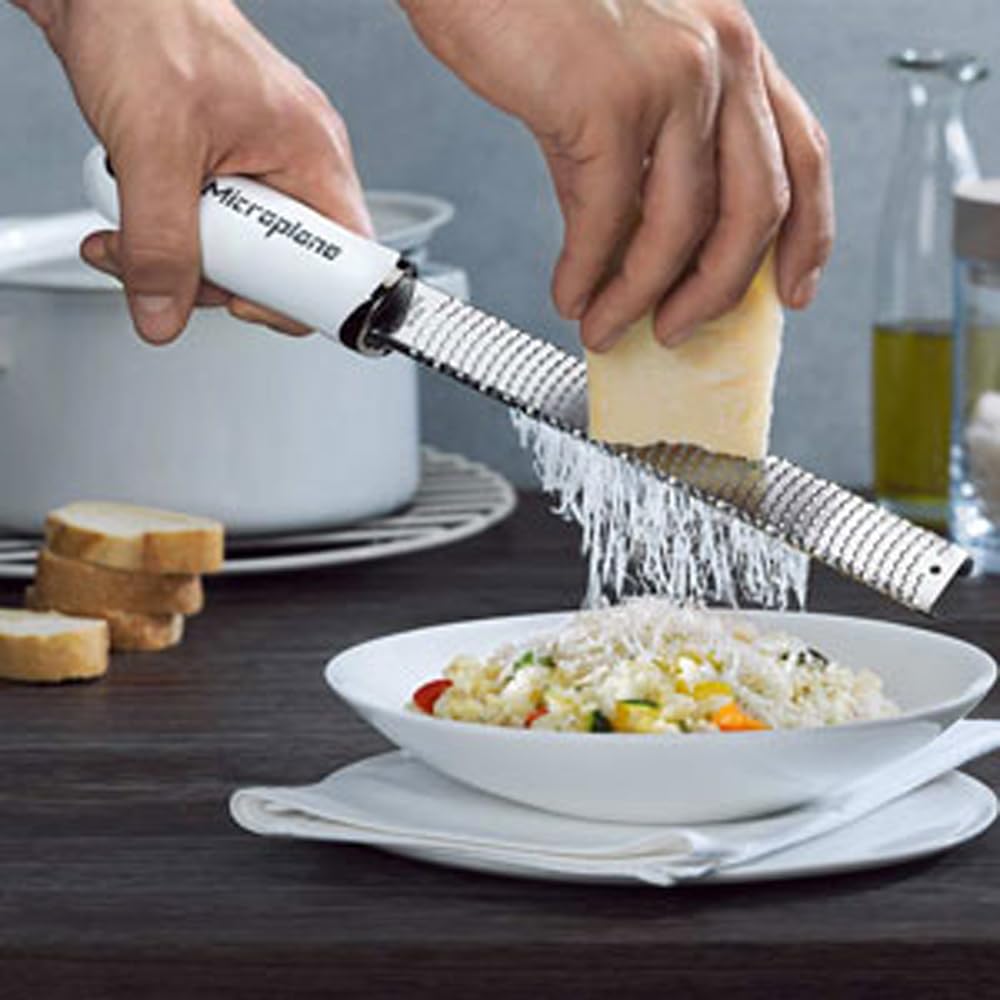 Close-up of zest blade creating citrus ribbons with minimal pith