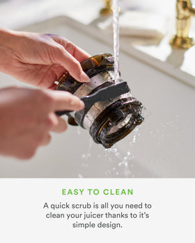 Nama J2 Juicer cleaning brush included for easy maintenance.